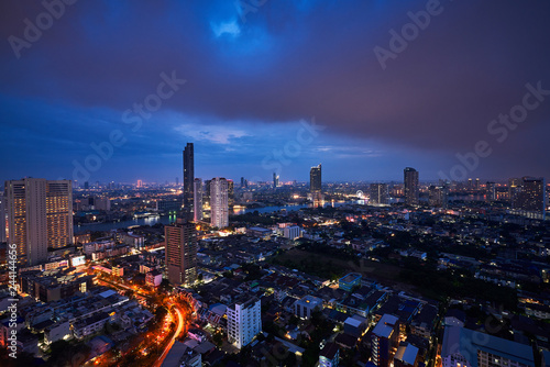 twilight sky and cityscape with the river and dark clouds