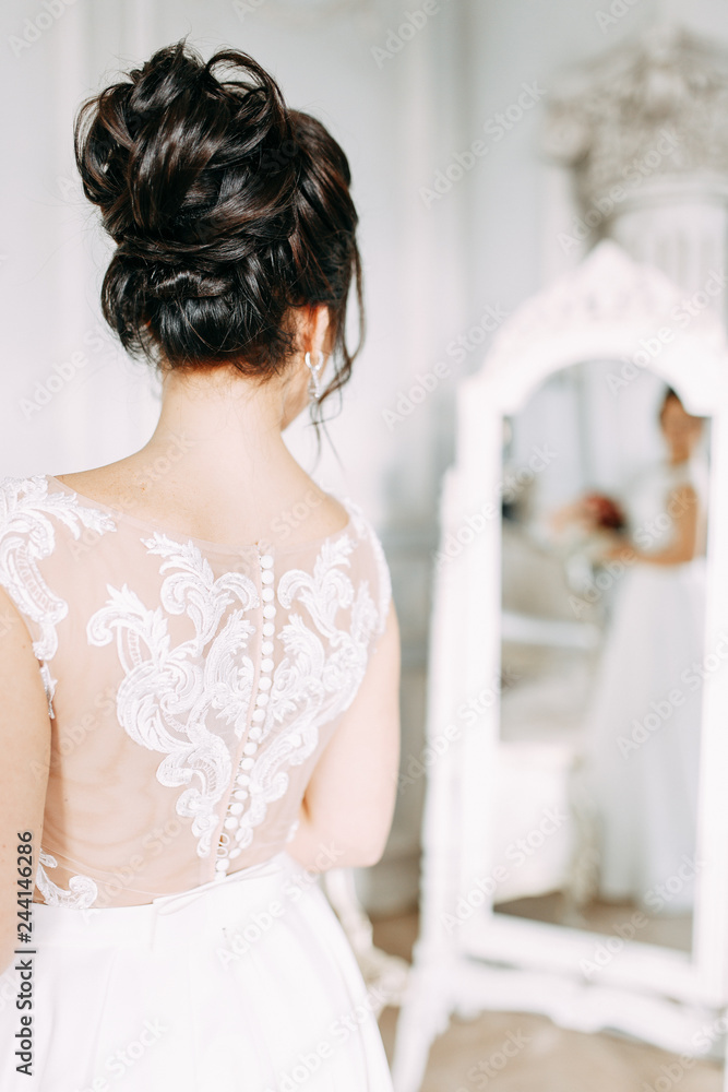 Bride in a bright Studio with a bouquet. Wedding dress and mirror. Bride in a bright Studio with a bouquet. Wedding dress and mirror.