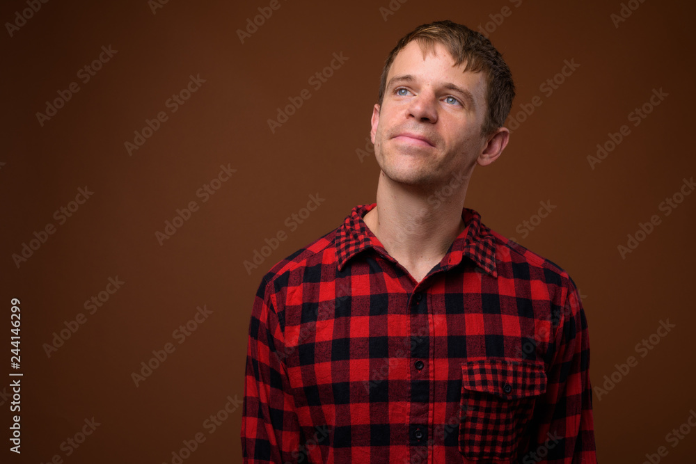 Man wearing red checkered shirt and thinking Man wearing red checkered shirt and thinking