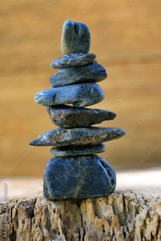 Black spa stones set up on old wood. Black spa stones set up on old wood.