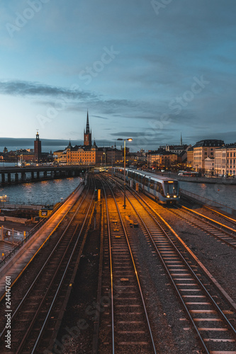 Photography Evening cityscape with subway train crossing the bridge of Gamla Stan, Stockholm, Sweden