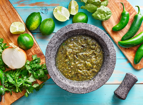 salsa verde in stone molcajete flat lay composition