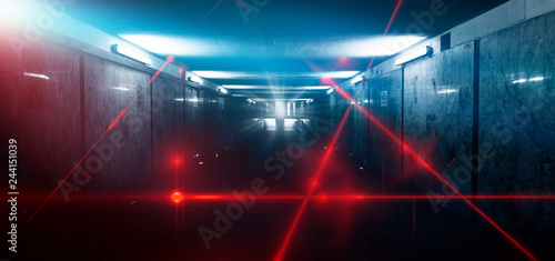 Dark room, street, tunnel, corridor, background with searchlight rays and a red laser beam, smoke, smog, dust. Abstract dark blue background with neon and rays.  © MiaStendal