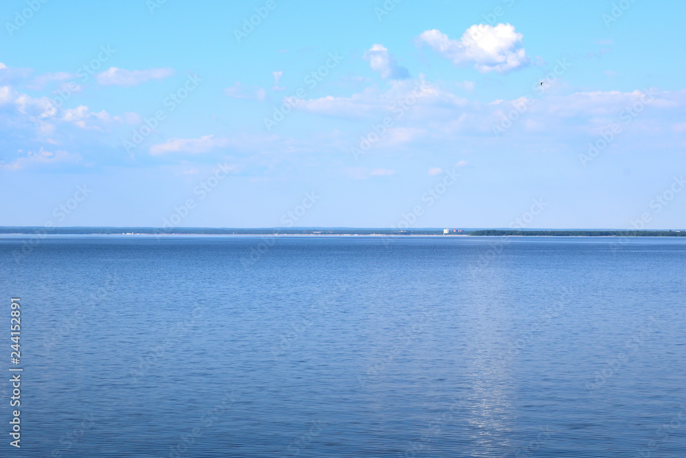Bright blue water merges with the same blue sky. Summer day, Gulf of Finland.
