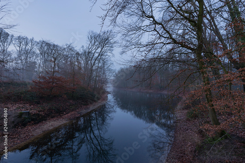 Krefeld - View from stone Brigde at Stadtwald  with tranquil creek at cold and Foggy Day / Germany © Manninx