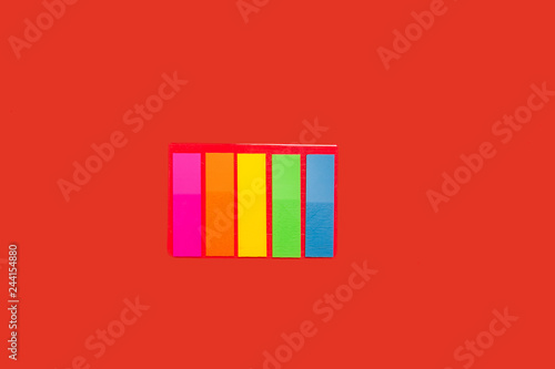 set of sticky notes lying on red background. concept of office stationary