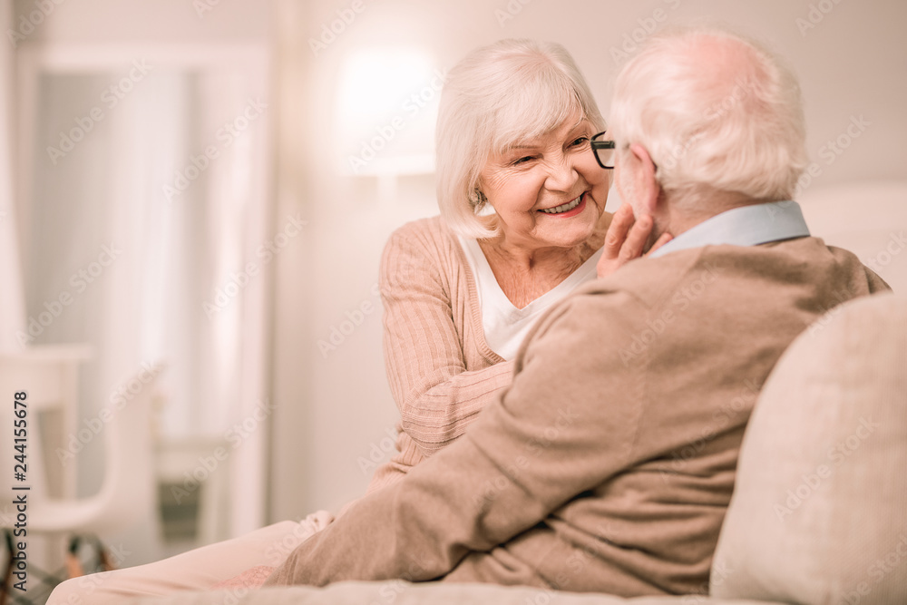 Attractive senior woman sitting close to her partner Attractive senior woman sitting close to her partner