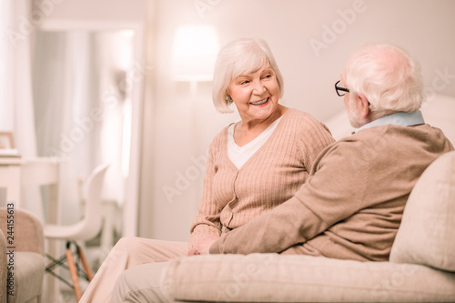 Charming blonde female person sitting near her partner