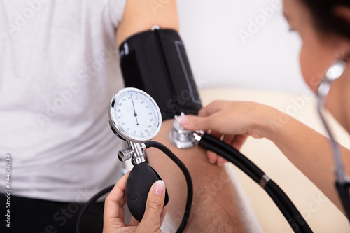 Doctor Measuring Blood Pressure Of Patient