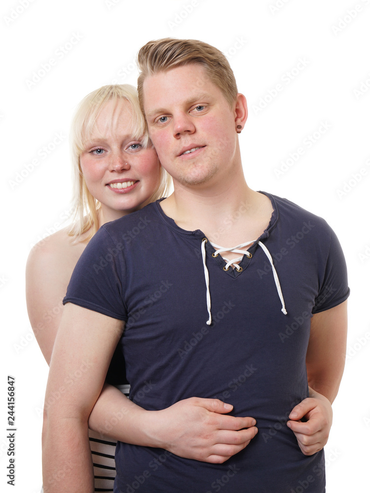 young couple woman hugging her boyfriend from behind young couple woman hugging her boyfriend from behind