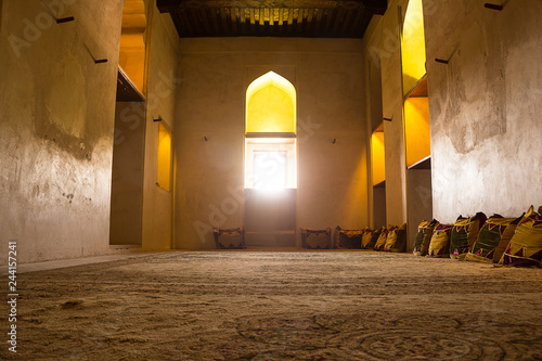 Inside Jabrin fort room with carpets and cushions and a window on the bottom photo