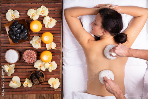 Woman Getting Massage With Herbal Compress Balls