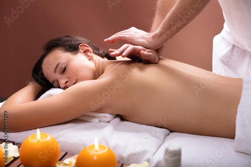 Therapist Giving Back Massage To Young Woman