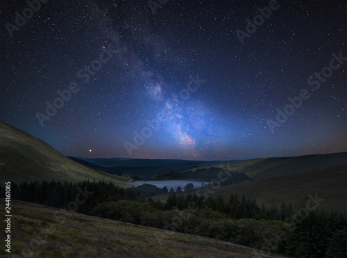 Vibrant Milky Way composite image over landscape of mountains in distance © veneratio
