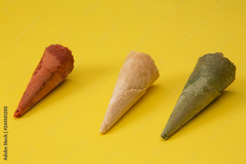 colorful ice cream cones on yellow background colorful ice cream cones on yellow background