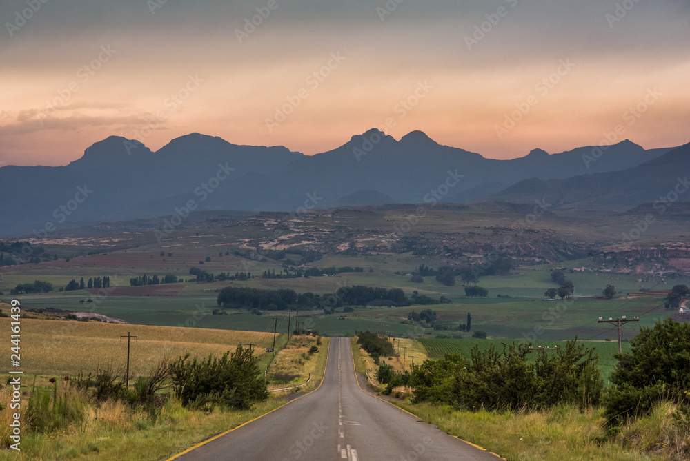 A road leading towards the Drakensberg mountains at sunrise near Clarens, South Africa A road leading towards the Drakensberg mountains at sunrise near Clarens, South Africa