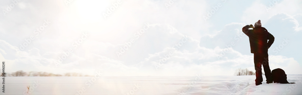 Fototapeta premium A man on a walk. Winter landscape. Tourist in winter journey.