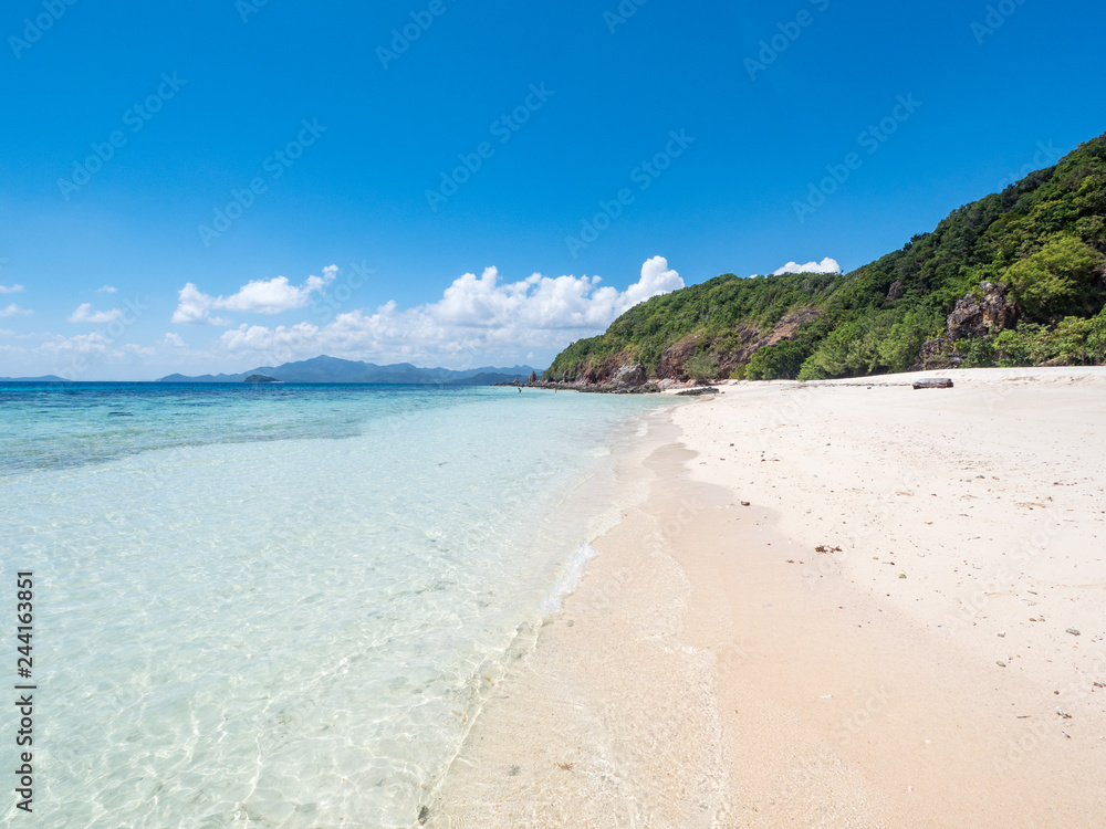 Beautiful white sand beach and blue sky. Coron, Busuanga island, Palawan province, Philippines. November, 2018
