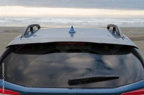 Exterior details of blue hatchback at sand beach in dusk light © Dmitri Kotchetov