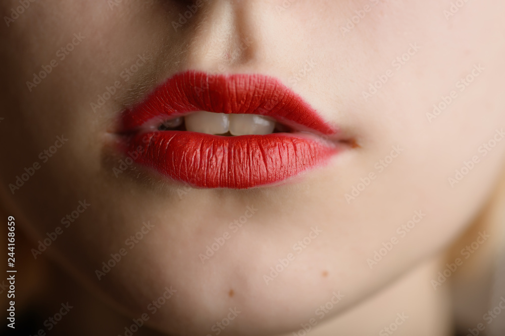 Fototapeta premium Beautiful female lips with red lipstick.