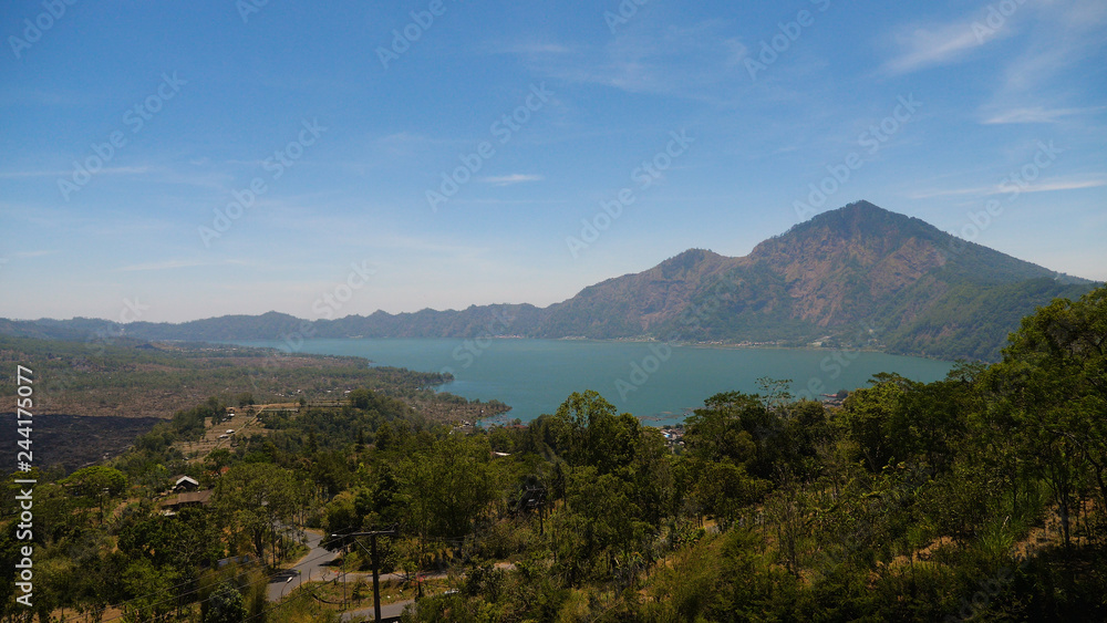 mountain landscape crater lake batur mountains with trees against blue sky Bali, Indonesia. Travel concept.