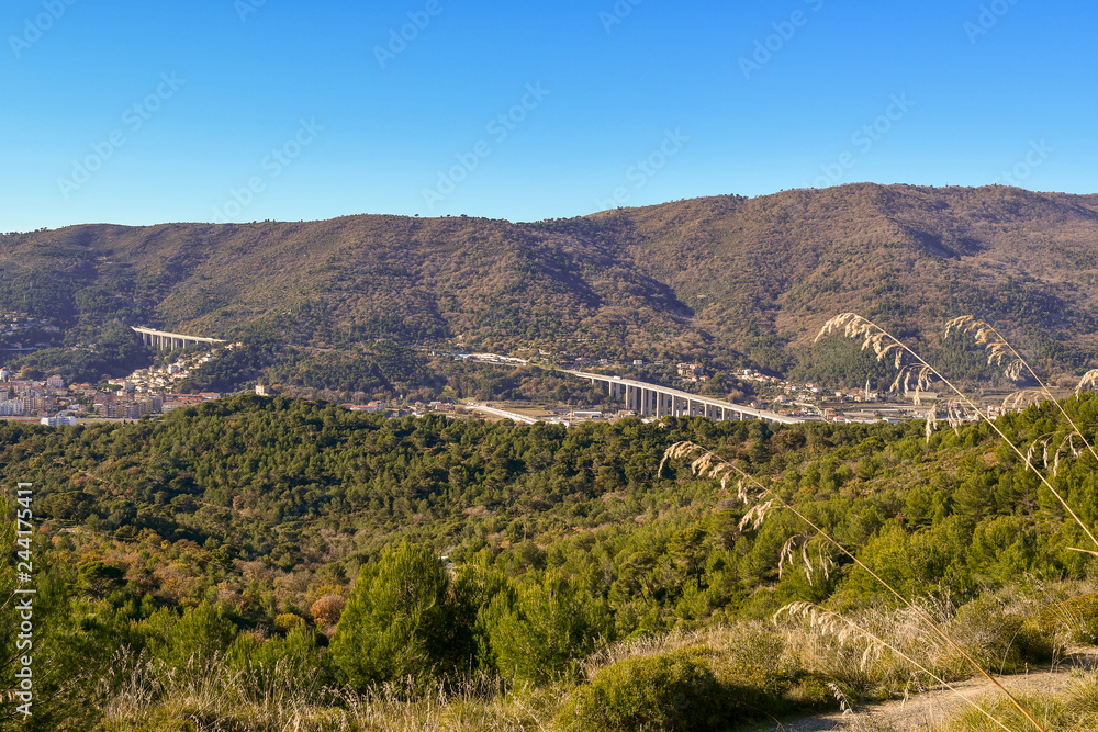 Panoramic view of the Ligurian Apennine mountains with highway from Capo Mele, Laigueglia, Liguria, Italy