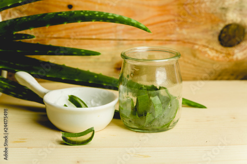 slices of fresh aloe on a calm, rustic, wooden background