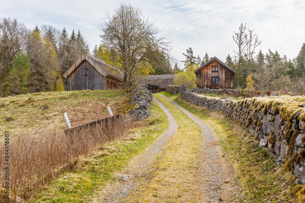 Old farm with a gravel road at the stone walls Old farm with a gravel road at the stone walls