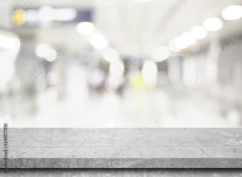 Empty stone table top on gray blur abstract background from inside shopping mall,Used for display or montage your products.