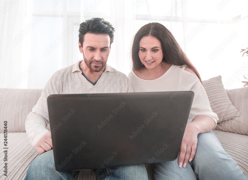 married couple watching a show on their laptop married couple watching a show on their laptop