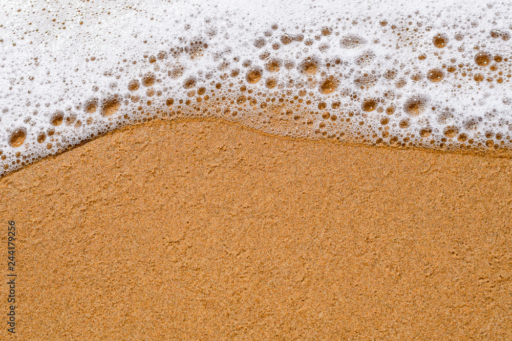Sea wave cools down on the sandy beach, background Sea wave cools down on the sandy beach, background
