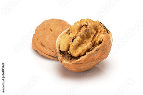 Open ripe walnut, with kernel and shell, close up macro, isolated on a white background.