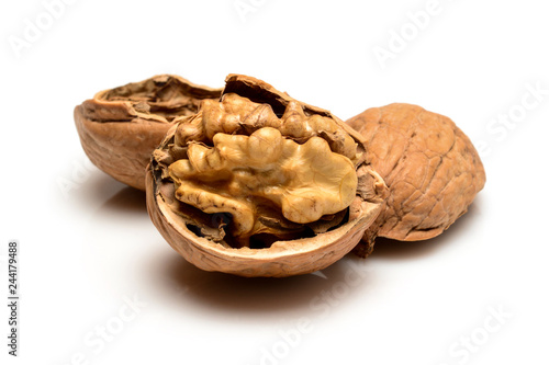 Opened ripe walnut with kernel and shell, close up macro, isolated on a white background.