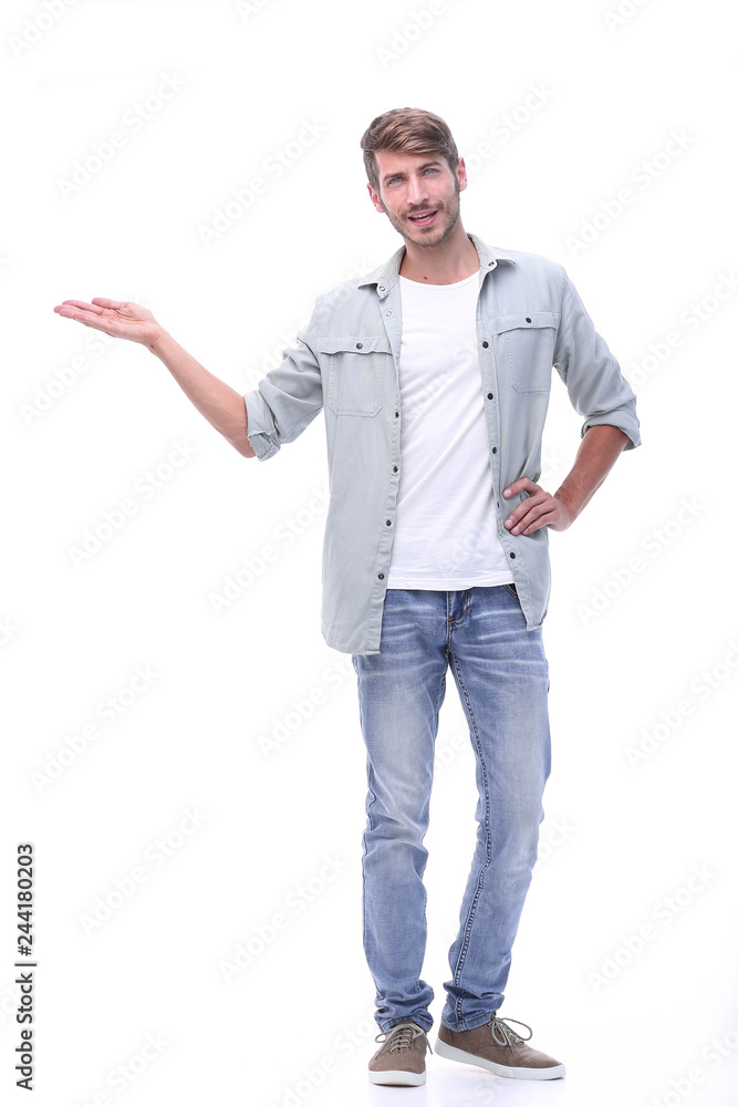 in full growth. successful young man showing on copy space. in full growth. successful young man showing on copy space.