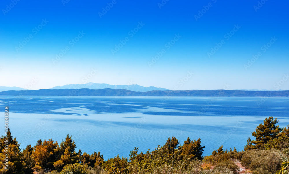 Coastal landscape. Sea coast with islands looming on the horizon.