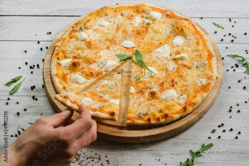 Pizza Formaggio with mozzarella, emental cheese, and cheese philadelphia on wooden background photo