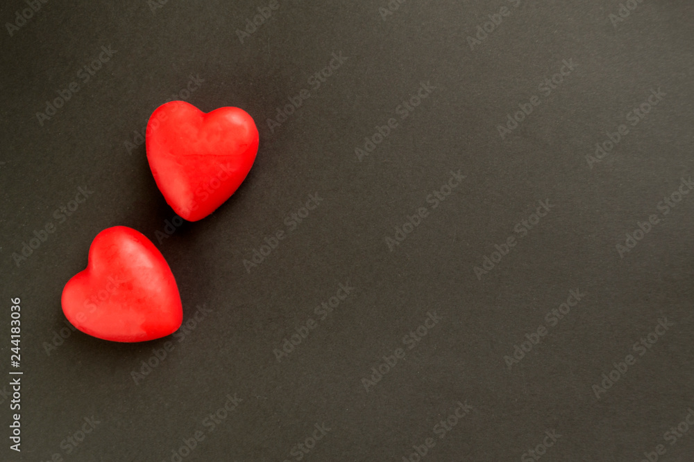 Obraz premium Valentine card with heart decor on a black table. Top view with space for your greeting.