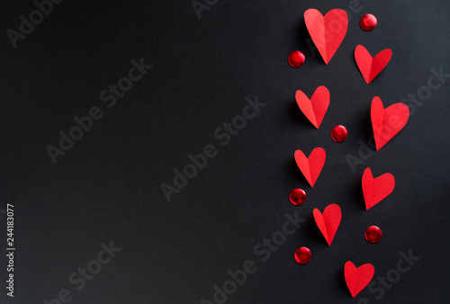 Valentine's day background with a lot of red hearts on a black background. photo