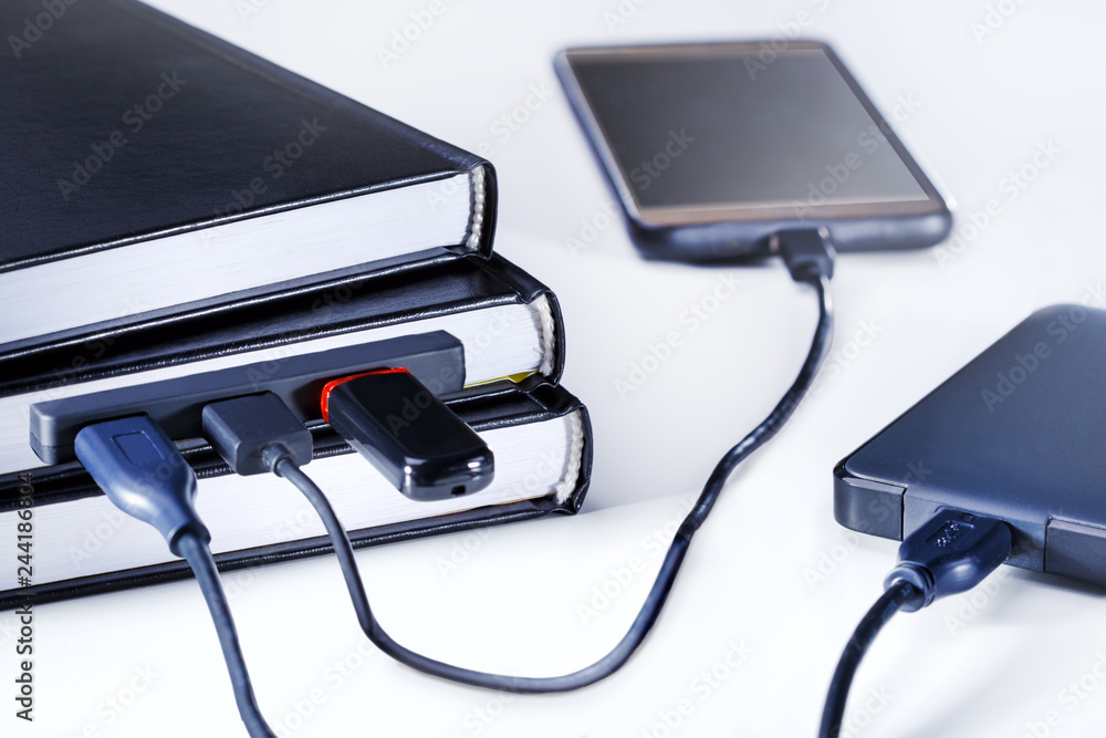 E-learning and e-book concept. With usb cable connecting to a books with gadget. Knowledge concep. E-learning and e-book concept. With usb cable connecting to a books with gadget. Knowledge concep.