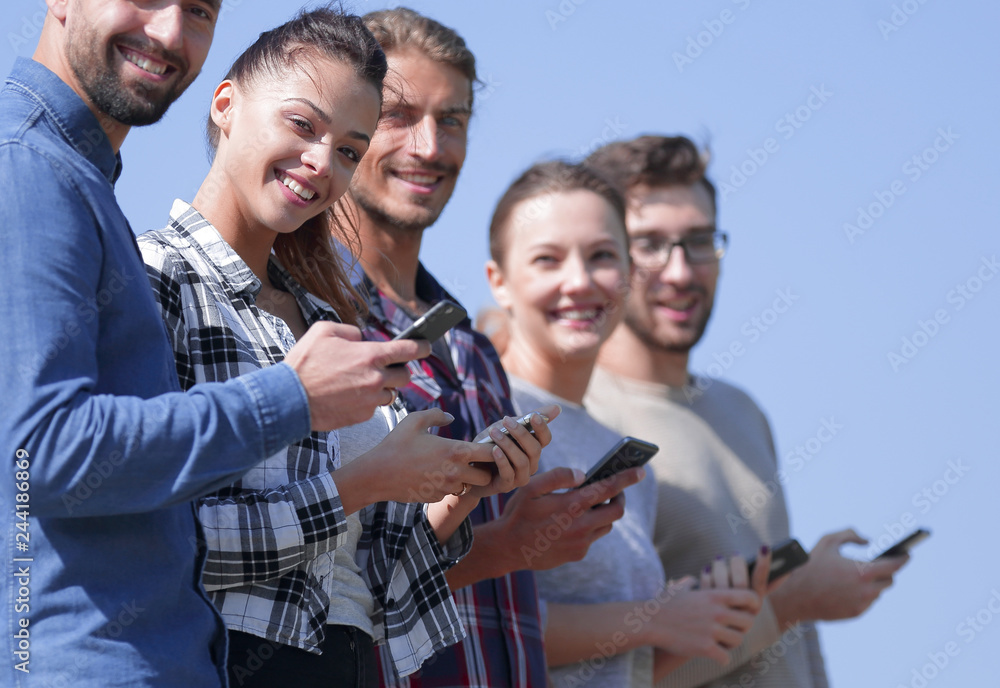 group of young people with modern smartphones. group of young people with modern smartphones.