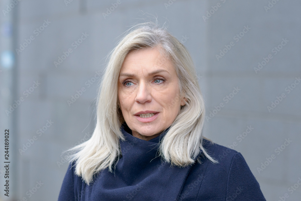 Fototapeta premium Thoughtful attractive blond woman looking aside