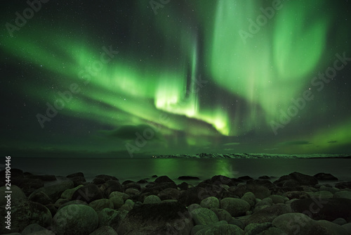 Bild auf Leinwand Northern light at the shore of the Barents sea