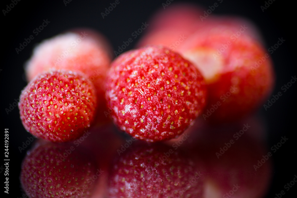 fresh frozen red ripe strawberries on a black fresh frozen red ripe strawberries on a black