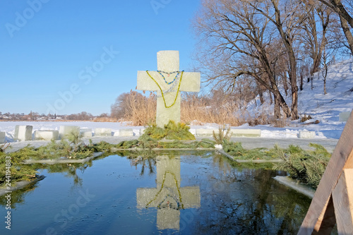 Epiphany ice hole and ice cross on a frozen lake