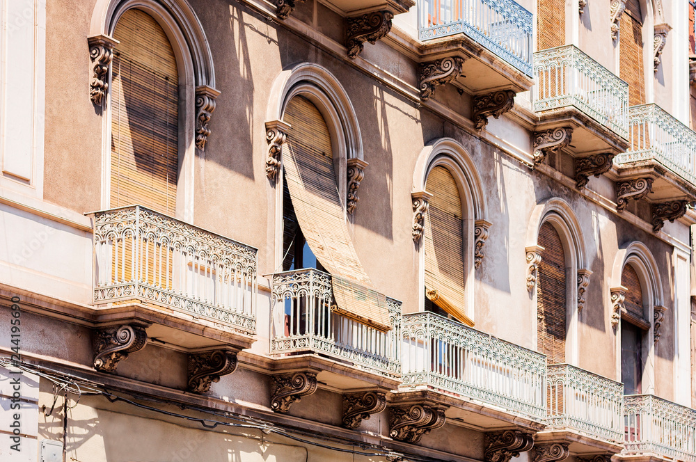 Balcony in a historic building in Catania, traditional architecture of Sicily, Italy