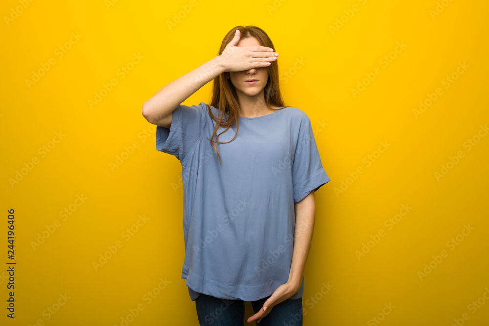 Young redhead girl over yellow wall background covering eyes by hands. Do not want to see something Young redhead girl over yellow wall background covering eyes by hands. Do not want to see something