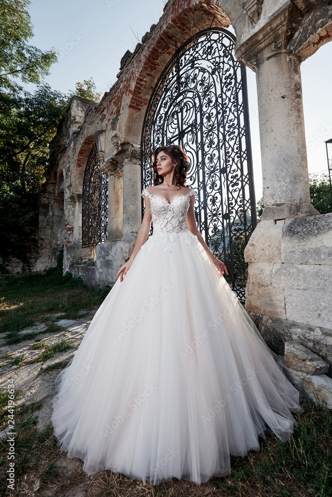 A woman in a wedding dress, enjoying happy moments of the happiest wedding day.