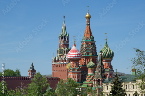 Pokrovsky Cathedral (St. Basil's Cathedral) and the Spasskaya tower of the Moscow Kremlin on a Sunny spring day. Moscow, Russia