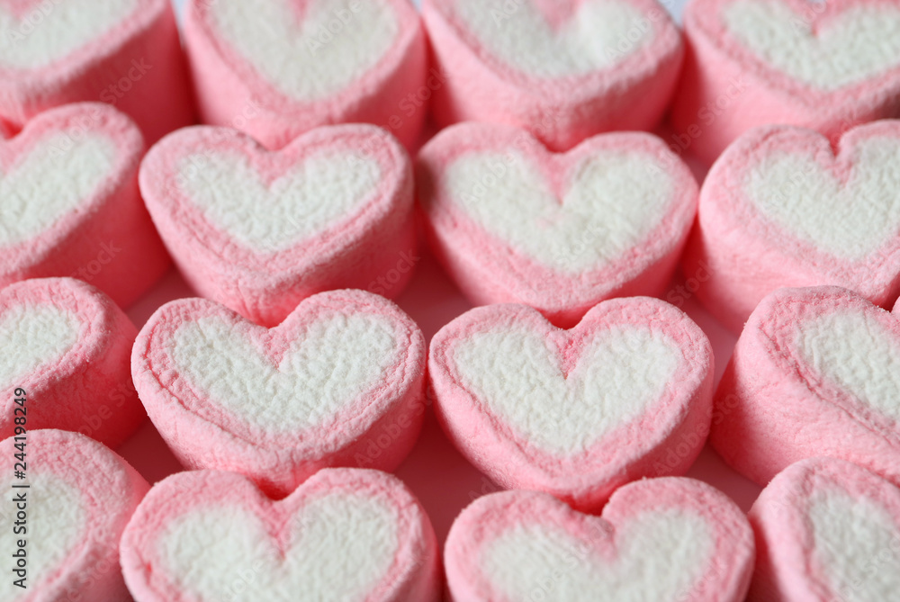 Obraz premium Lined Up Pastel Pink and White Heart Shaped Marshmallow Candies for Background, Banner, Pattern 