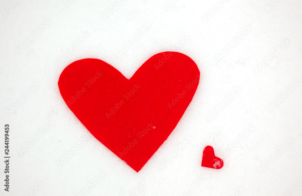 Red heart on the snow white background